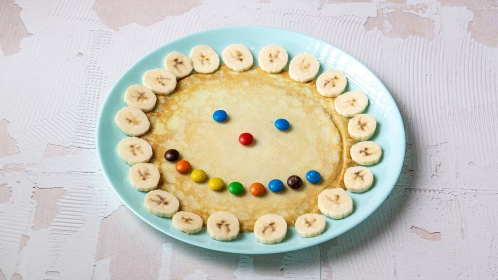 Pancakes with Banana, Dragees and Chocolate Topping